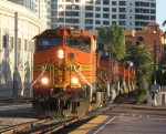 BNSF 4468 leads 5 other locos on a train past the old depot